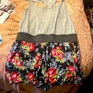 This is a romper with a grey too half and a black with flower bottom half
